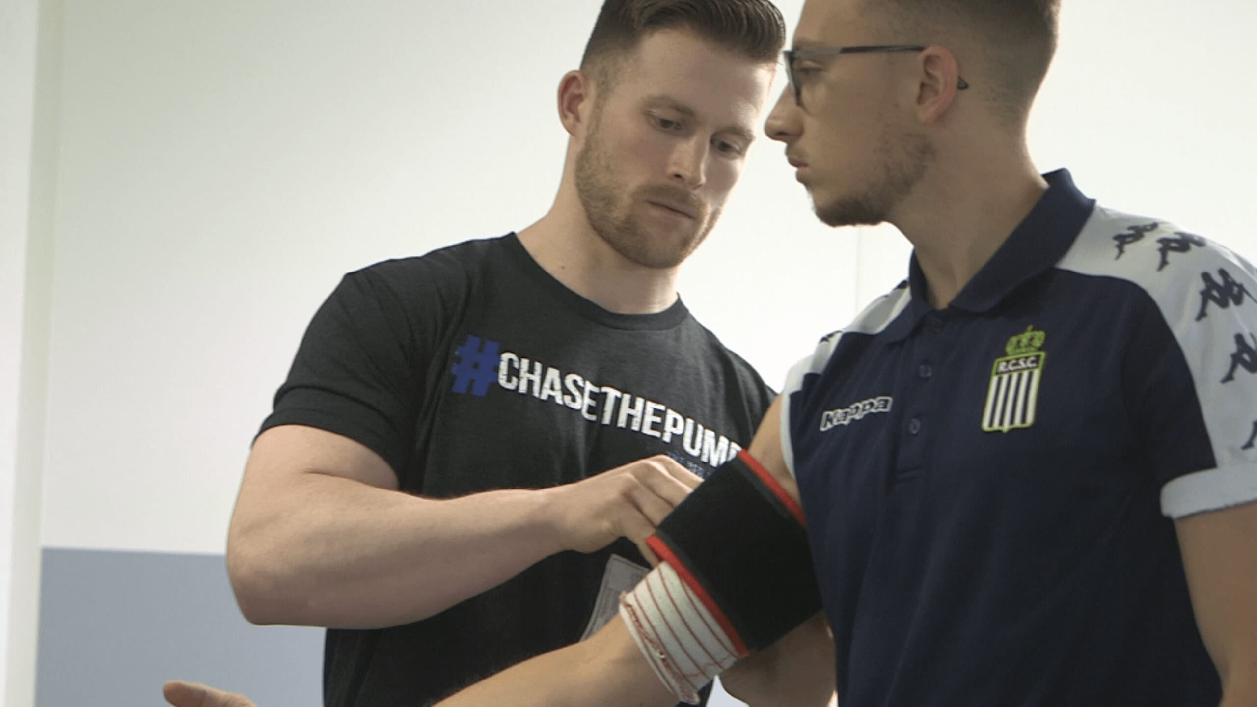 Dr. Nicholas Rolnick applying a blood flow restriction cuff to a patient